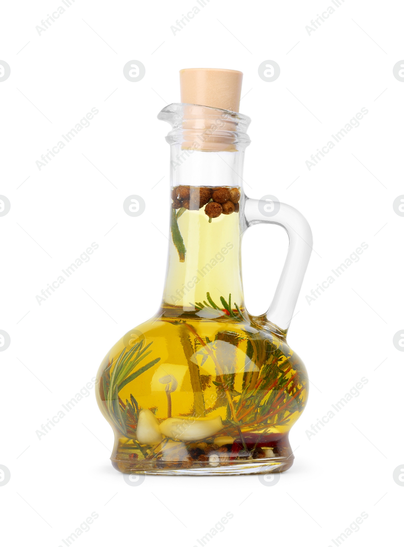 Photo of Glass jug of cooking oil with spices and herbs isolated on white