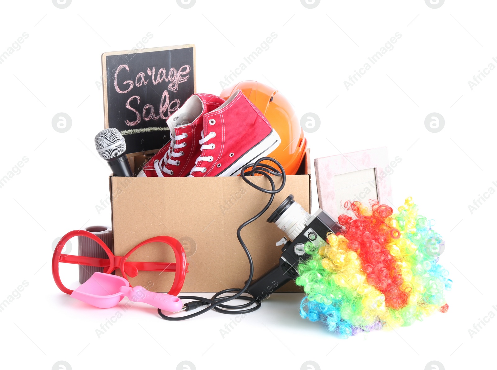 Photo of Box of unwanted stuff isolated on white. Garage sale