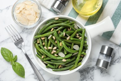 Tasty salad with green beans served on white marble table, flat lay