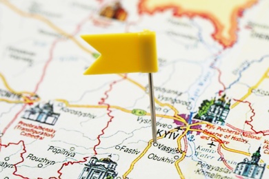 Photo of MYKOLAIV, UKRAINE - NOVEMBER 09, 2020: Kyiv city marked with push pin on map of Ukraine, closeup