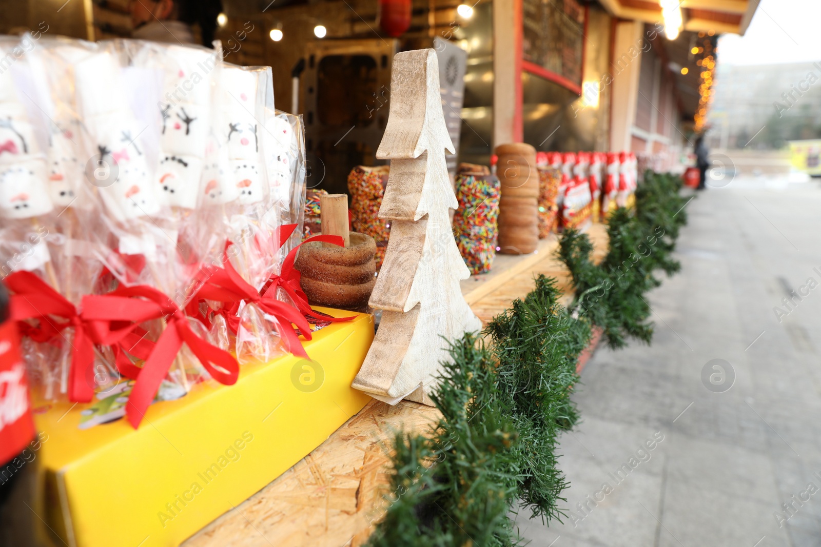 Photo of Christmas fair stall outdoors, focus on decor