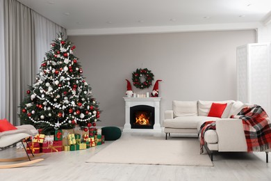 Beautiful Christmas tree and many gift boxes in stylish living room interior