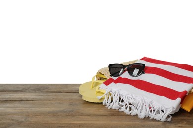 Beach bag with towel, flip flops and sunglasses on wooden surface against white background. Space for text