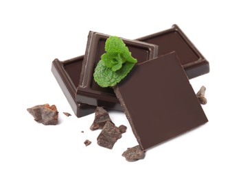 Photo of Tasty dark chocolate pieces with mint on white background