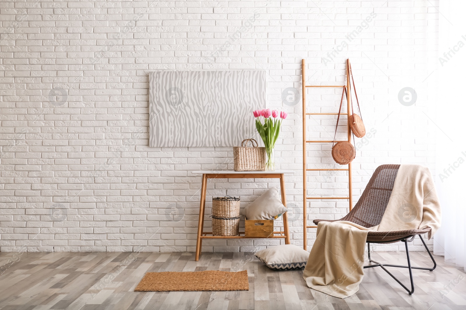 Photo of Stylish living room interior with cozy armchair near brick wall. Space for text