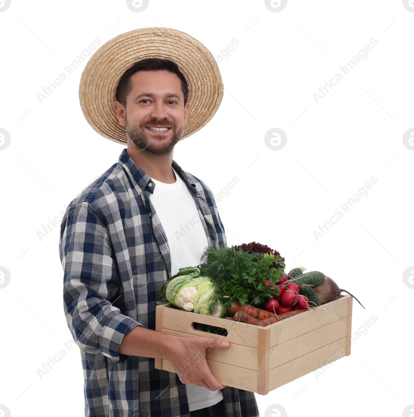 Photo of Harvesting season. Happy farmer holding wooden crate with vegetables on white background