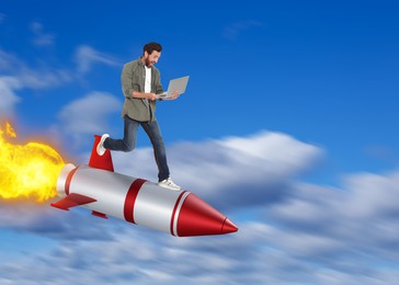 Image of Rapid success. Happy man with laptop on rocket rushing through sky. Illustration of spaceship