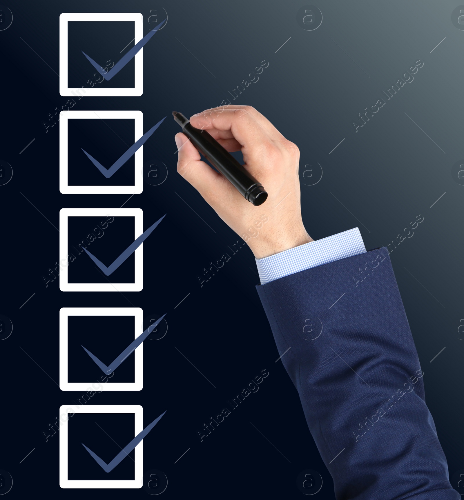 Image of Man with marker and check boxes with ticks on dark background, closeup