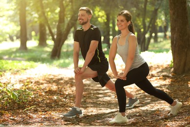 Photo of Man and woman doing morning exercise in park