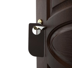Photo of Hotel wooden door with blank hanger on white background, closeup
