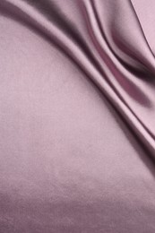 Photo of Crumpled dark purple silk fabric as background, top view. Space for text