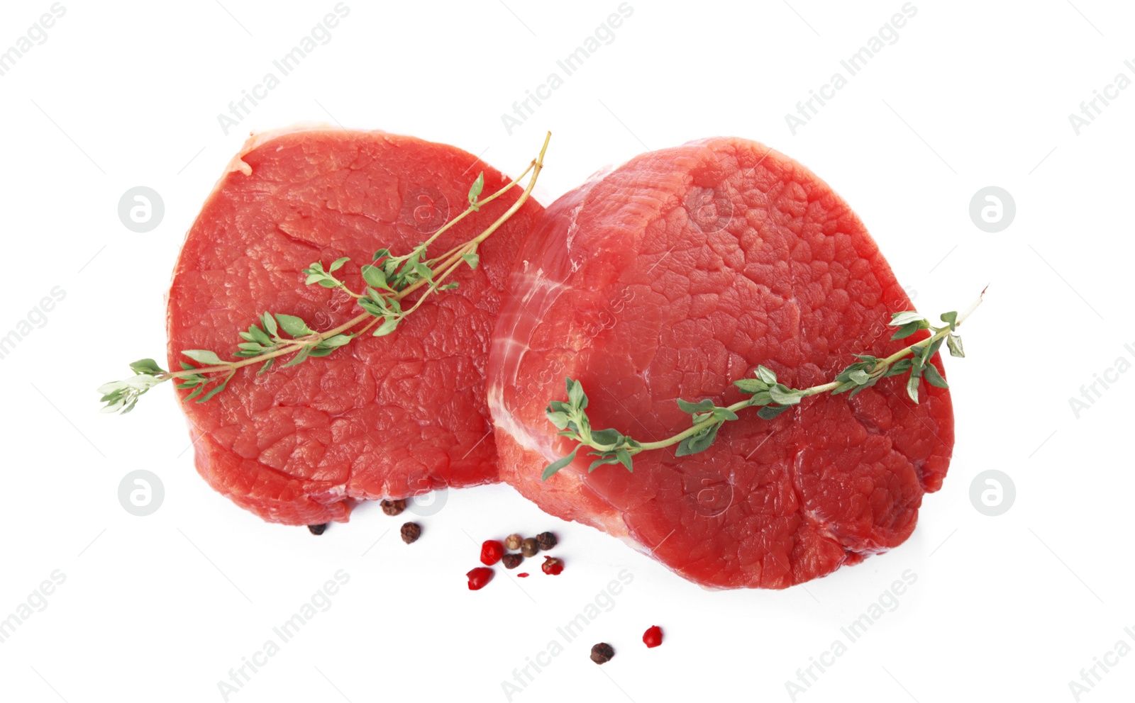 Photo of Fresh raw beef cut with thyme and peppers mix isolated on white, top view