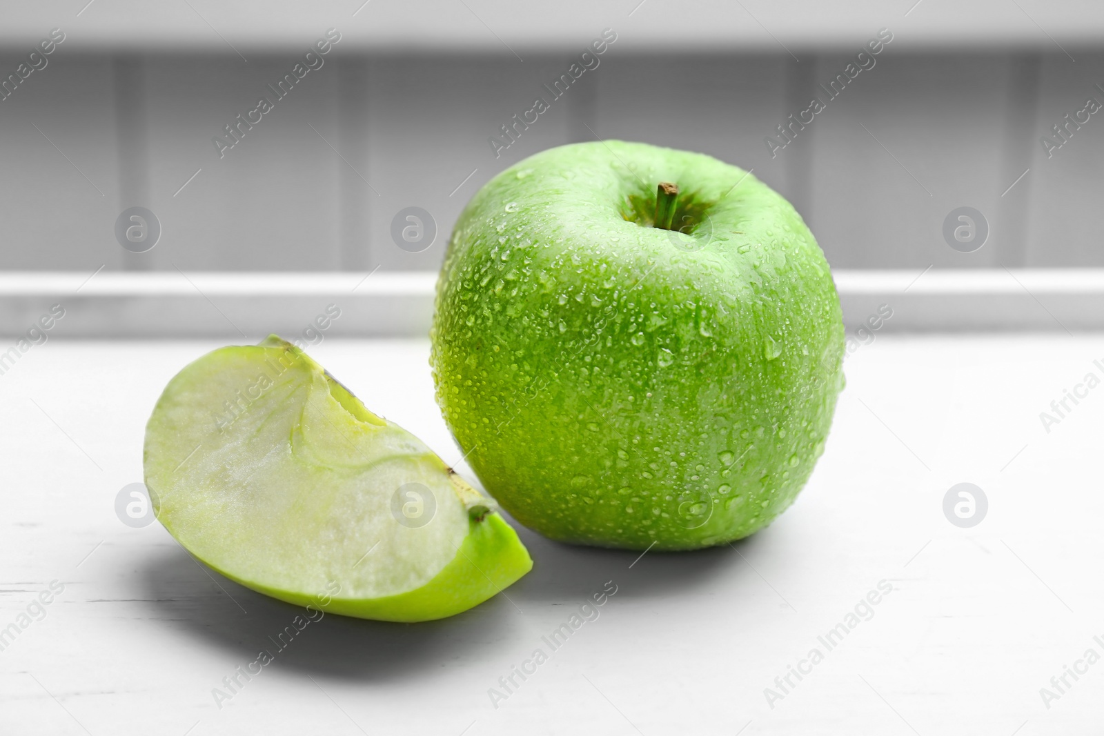 Photo of Fresh green apple and slice on table