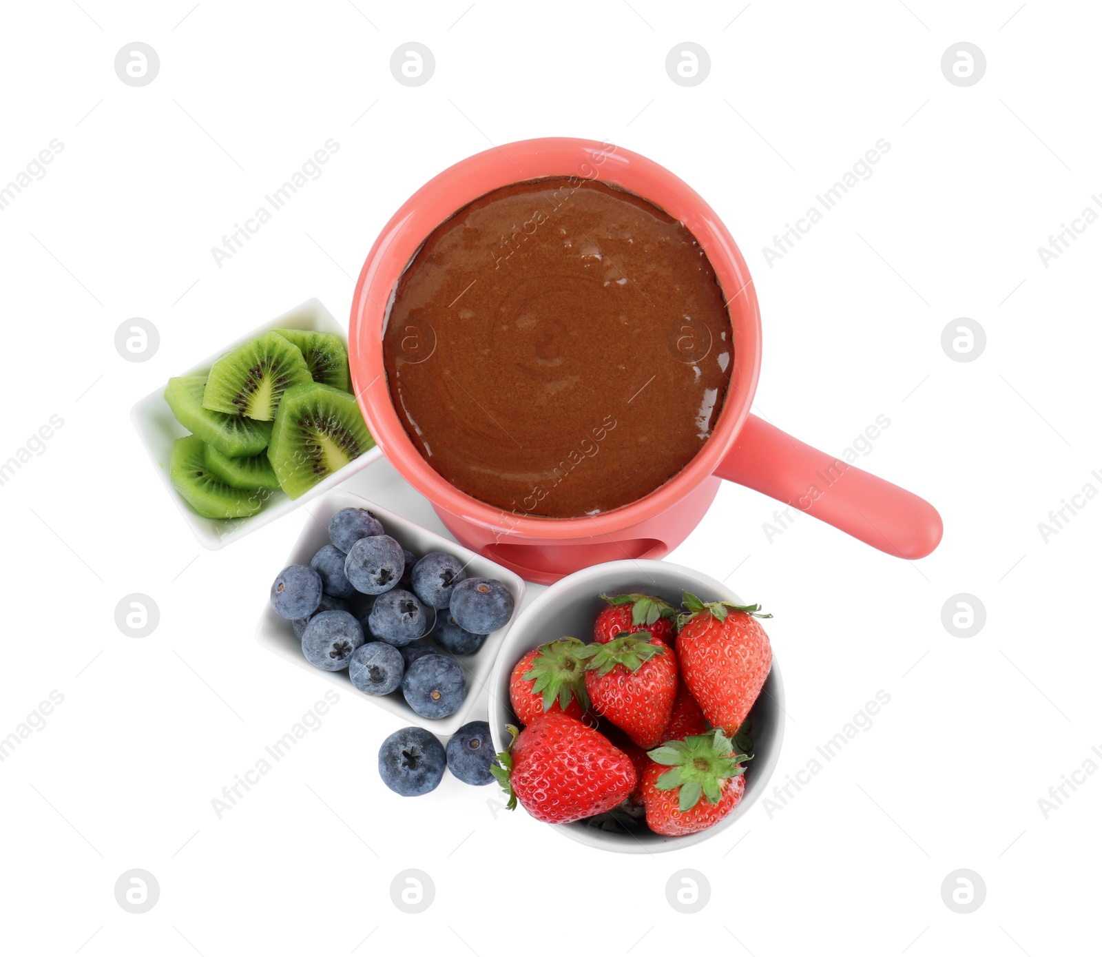 Photo of Fondue pot with melted chocolate, fresh berries and kiwi isolated on white, top view