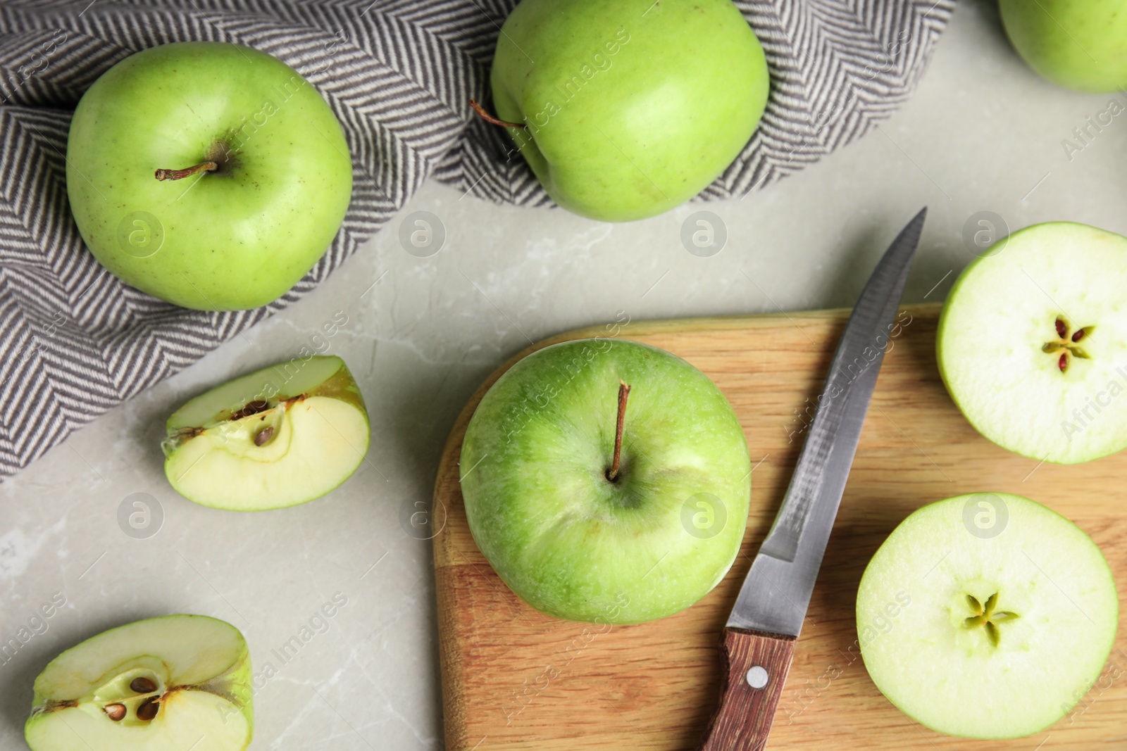 Photo of Flat lay composition of fresh ripe green apples on grey stone table