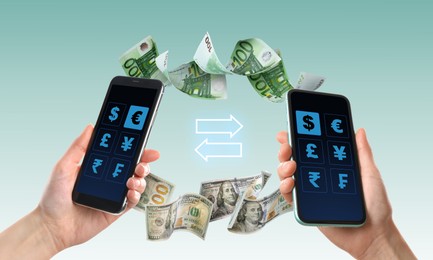 Image of Online money exchange. Women with mobile phones, closeup. Dollar and euro banknotes flying between devices on color background