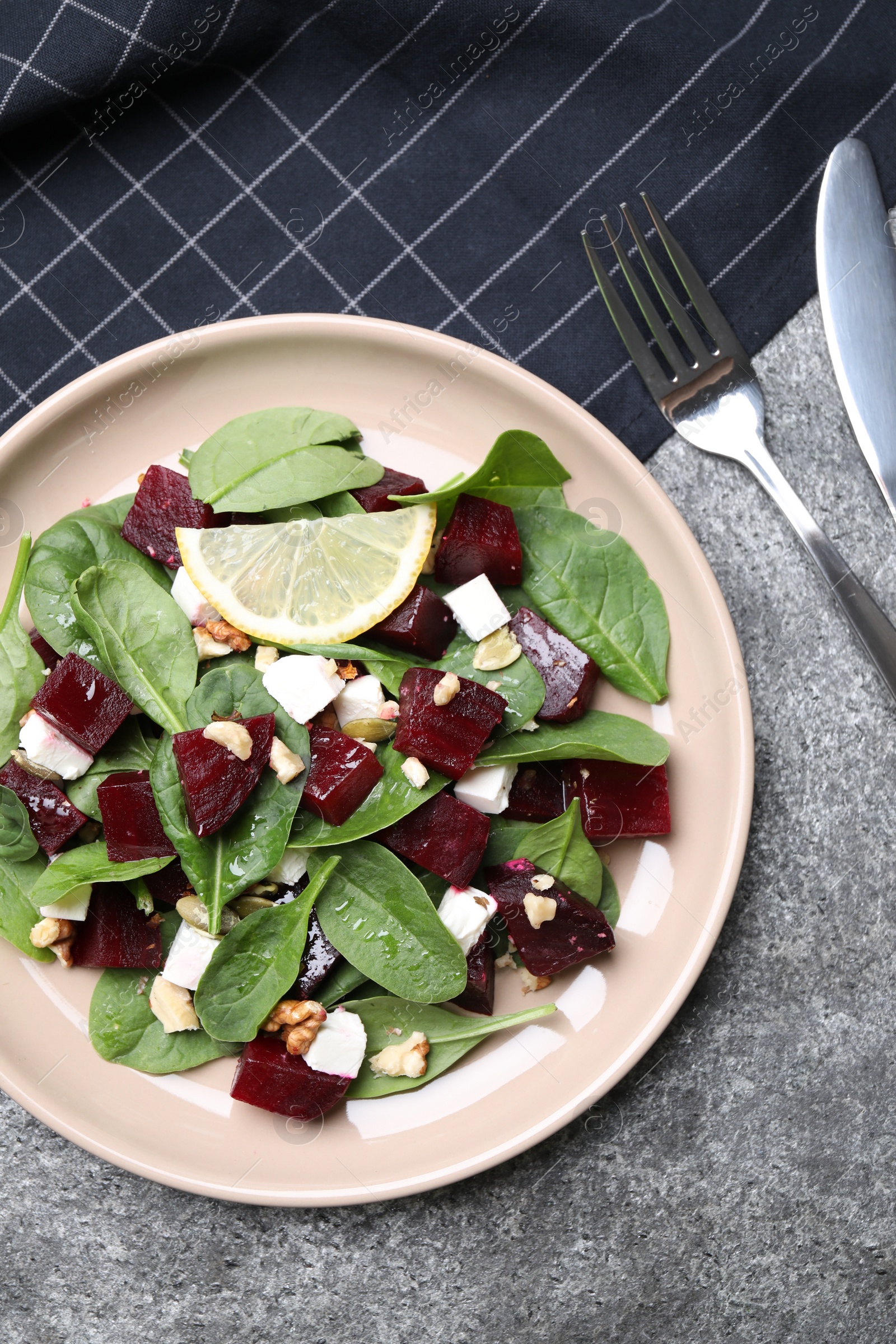 Photo of Delicious beet salad served on grey table, flat lay