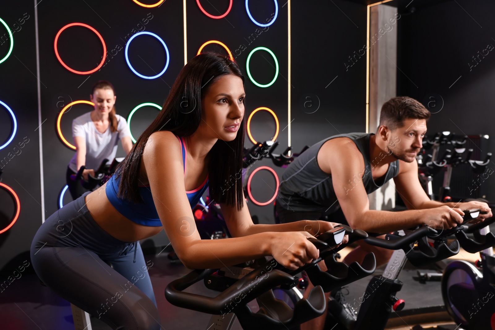 Photo of Group of people training on exercise bikes in fitness club