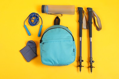 Different sports equipment on yellow background, flat lay