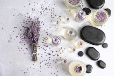 Photo of Flat lay composition with natural herbal oil and lavender flowers on light background