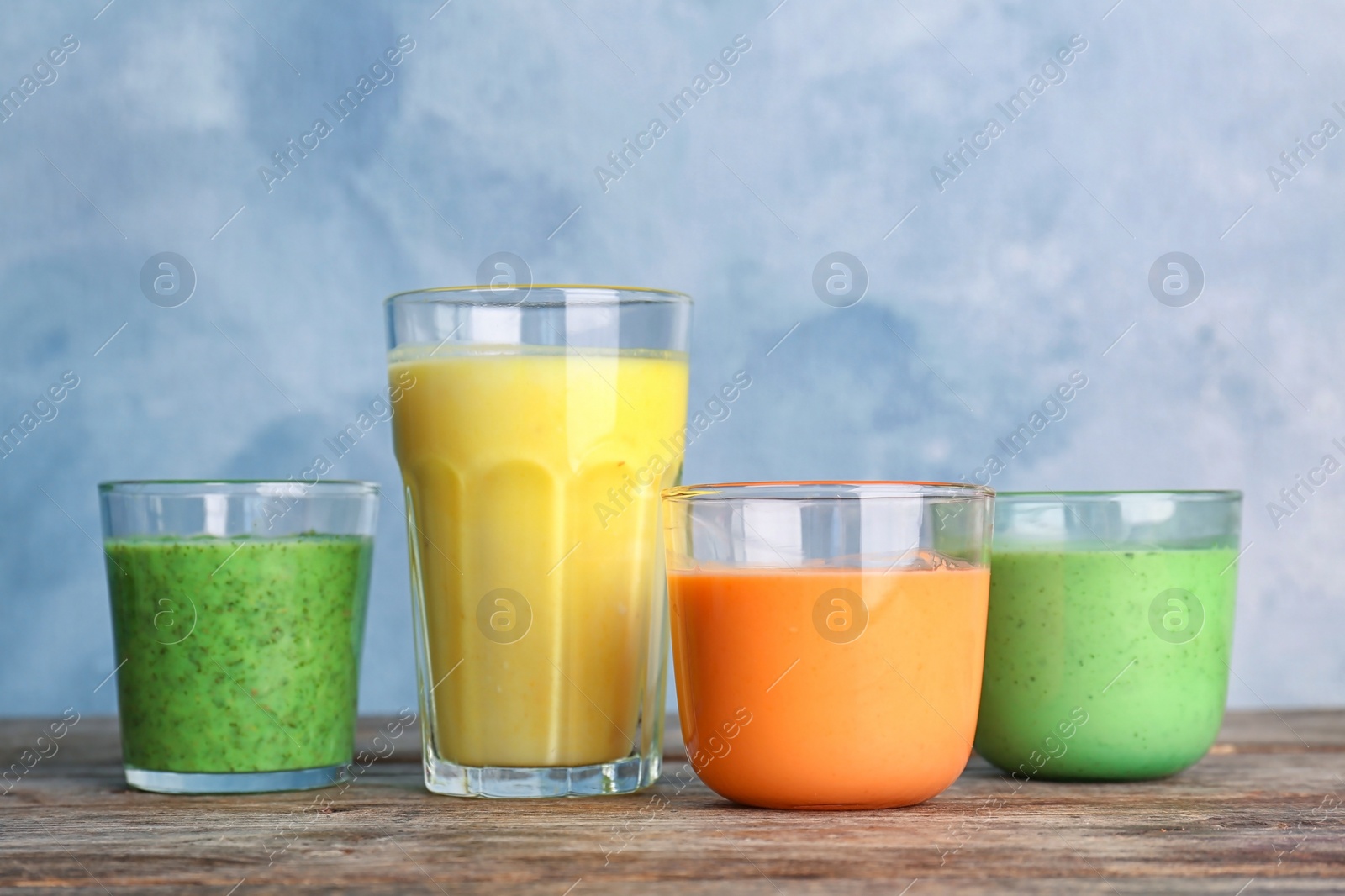 Photo of Glasses with delicious detox smoothies on table