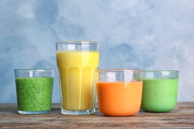 Glasses with delicious detox smoothies on table