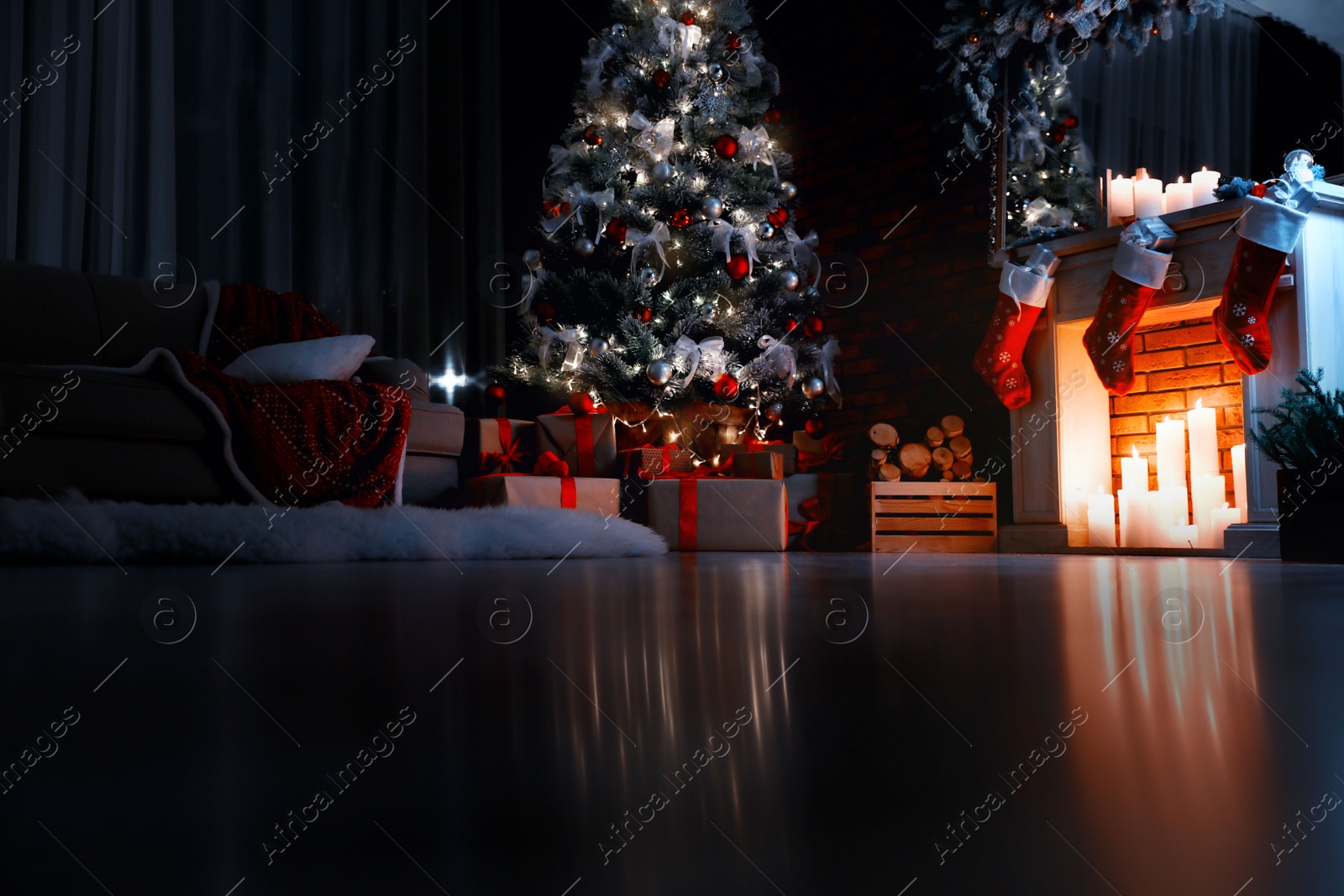 Photo of Stylish room interior with beautiful Christmas tree in evening