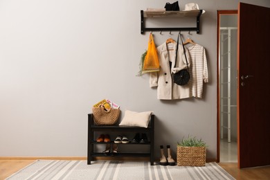 Hallway interior with stylish furniture, clothes and accessories