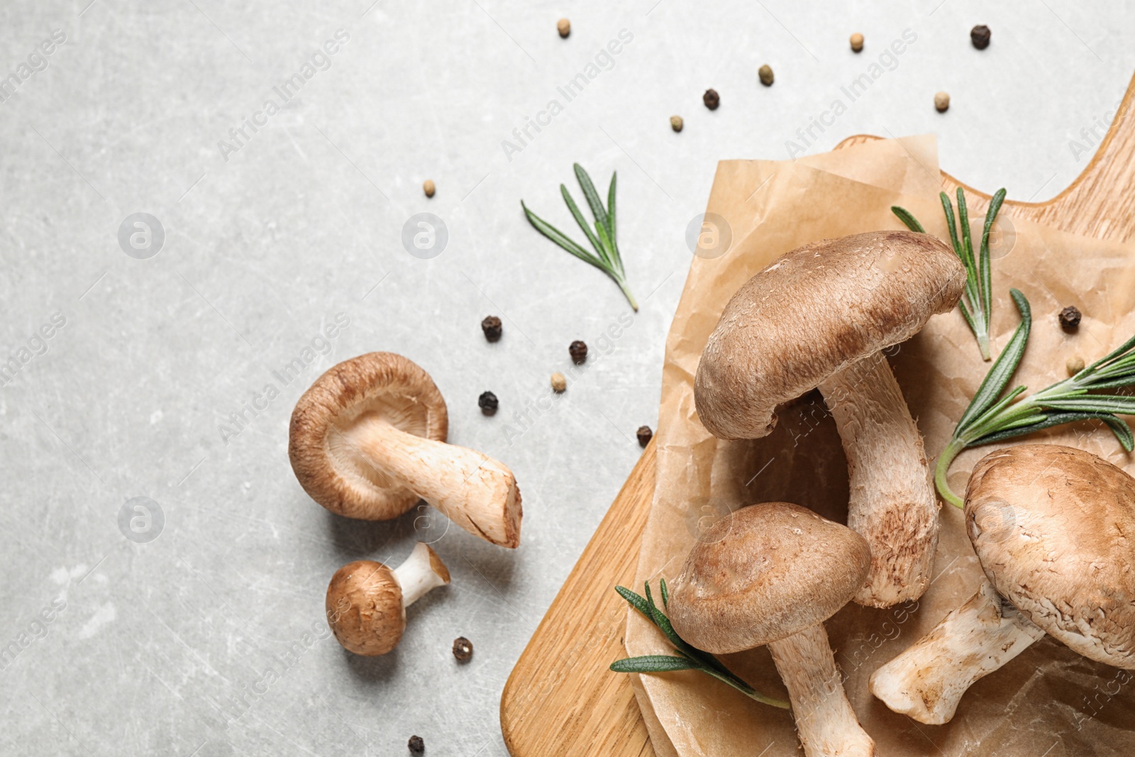 Photo of Flat lay composition with fresh wild mushrooms on light grey table