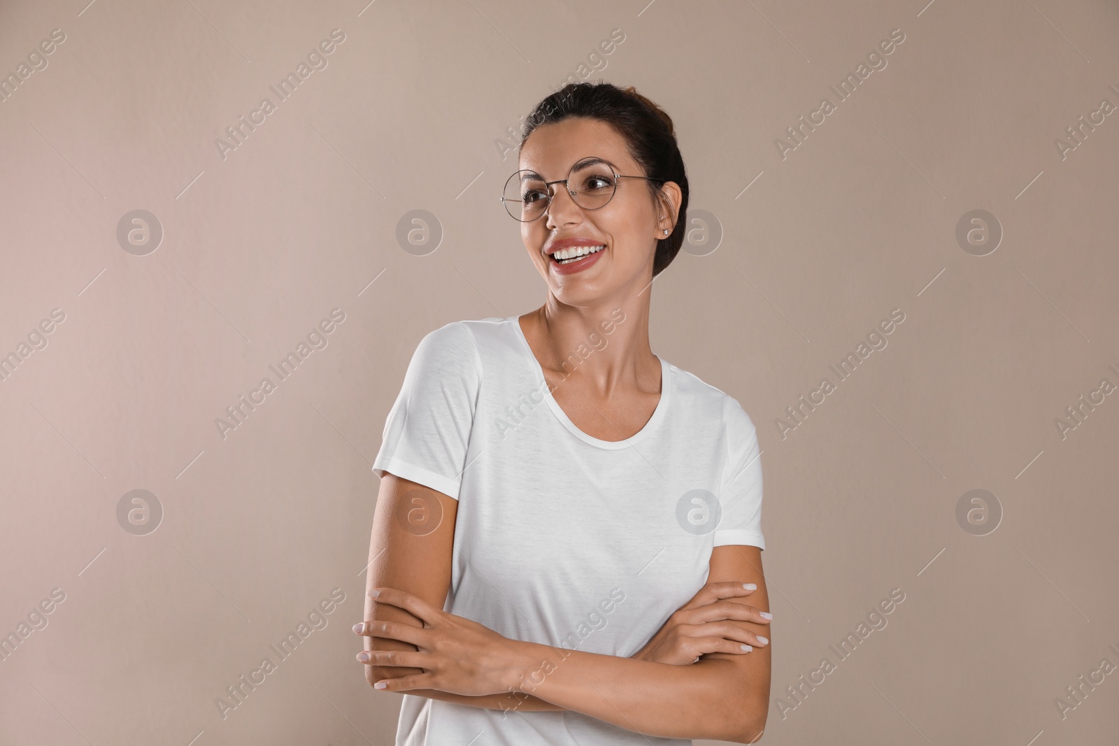 Photo of Beautiful woman in eyeglasses on light brown background