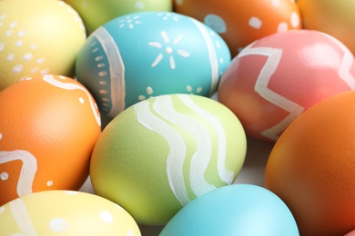 Many beautiful painted Easter eggs as background, closeup