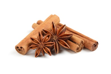 Dry anise stars and cinnamon sticks on white background