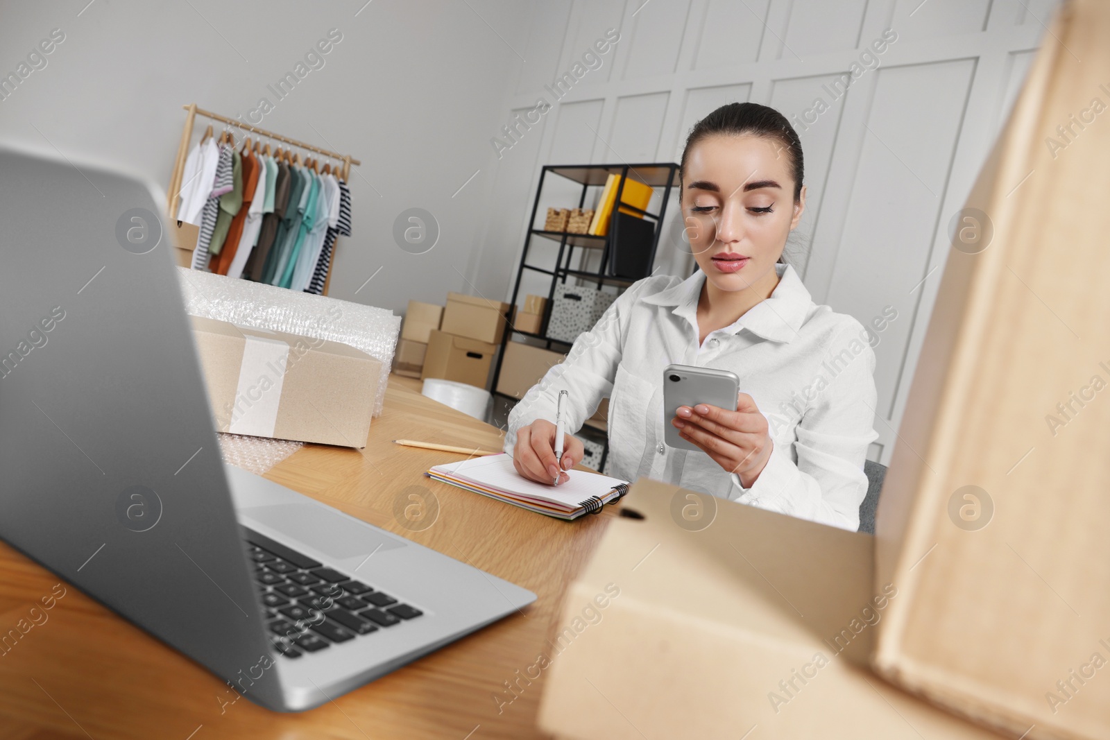 Photo of Seller working at table in office. Online store