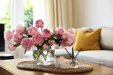 Beautiful pink peonies in vase on table at home. Interior design