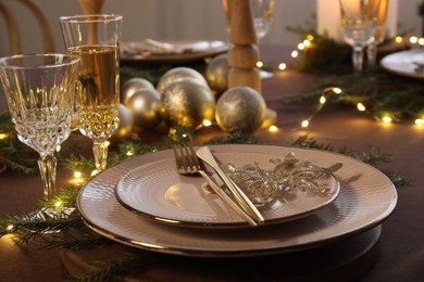 Photo of Table setting with festive lights and Christmas decor