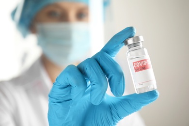 Doctor holding vial with vaccine against Covid-19, closeup