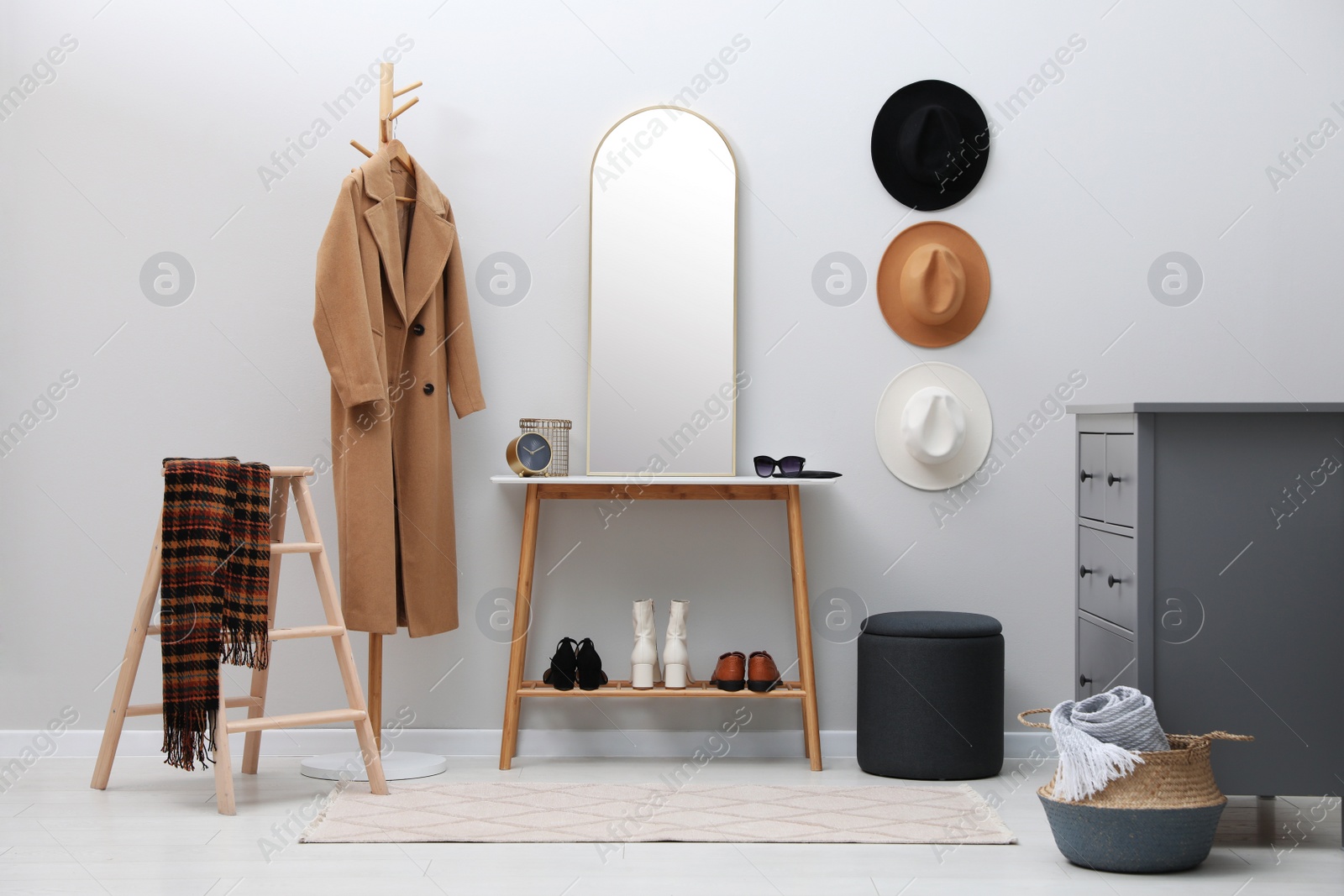 Photo of Stylish hallway interior with mirror and table near light wall