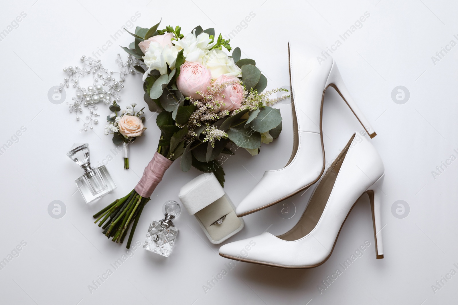 Photo of Composition with wedding high heel shoes on white background, top view