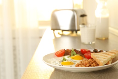 Photo of Tasty breakfast with fried eggs on wooden table