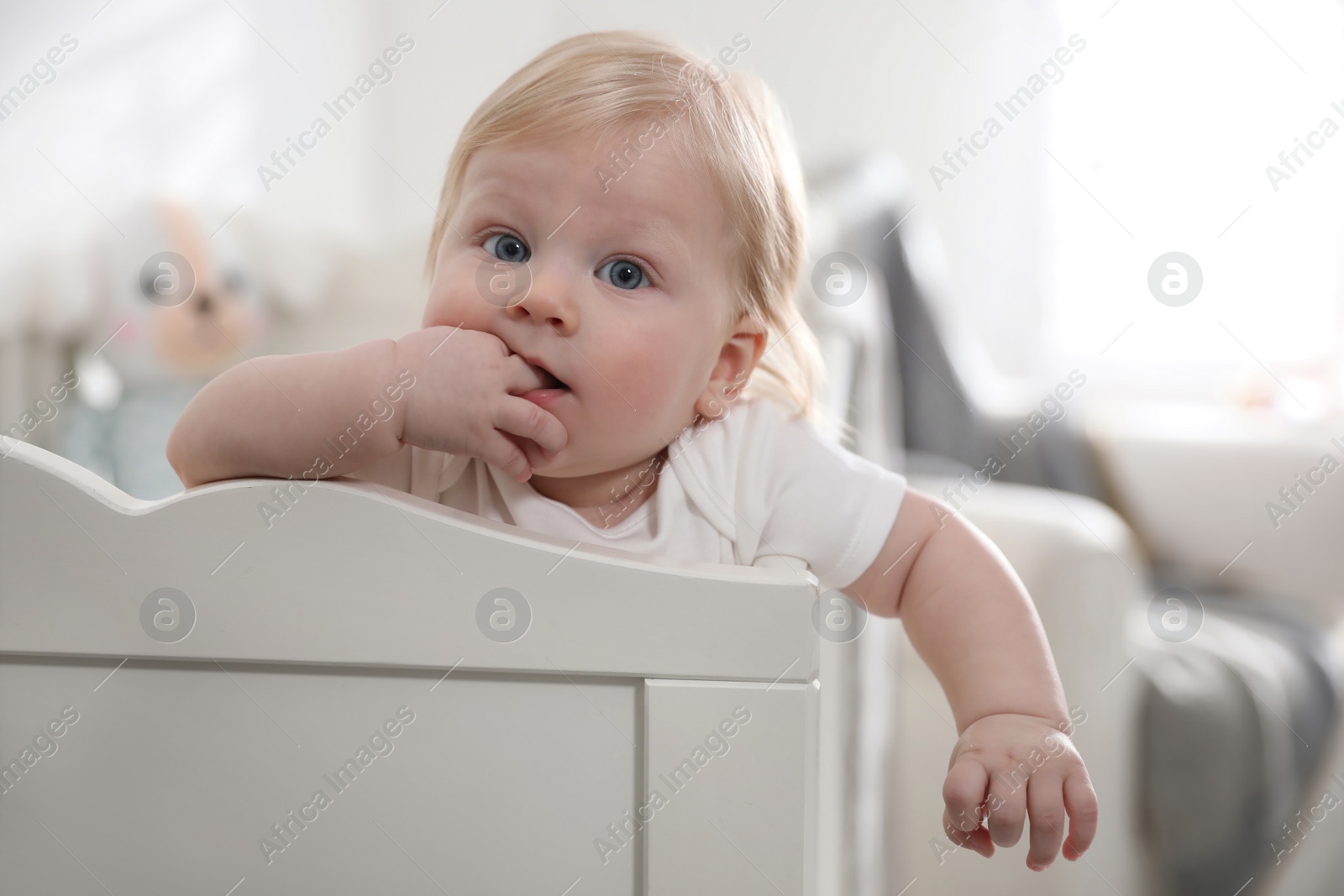 Photo of Adorable little baby in crib at home