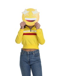 Woman holding emoticon with stars instead of eyes on white background