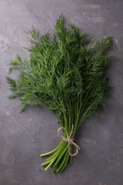 Bunch of fresh dill on grey textured table, top view