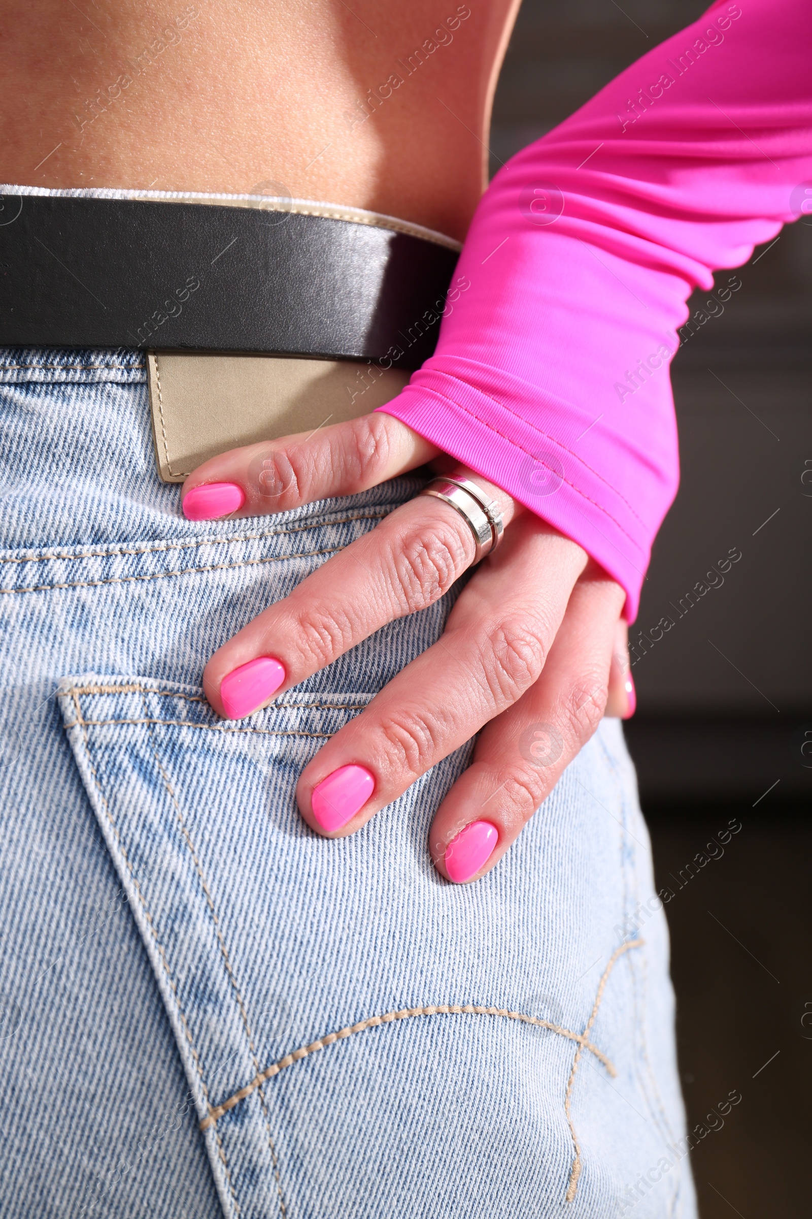 Photo of Woman showing manicured hand with pink nail polish, closeup