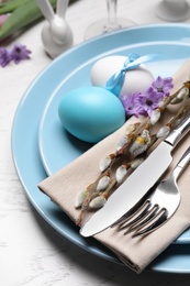 Photo of Festive Easter table setting with eggs on white background, closeup
