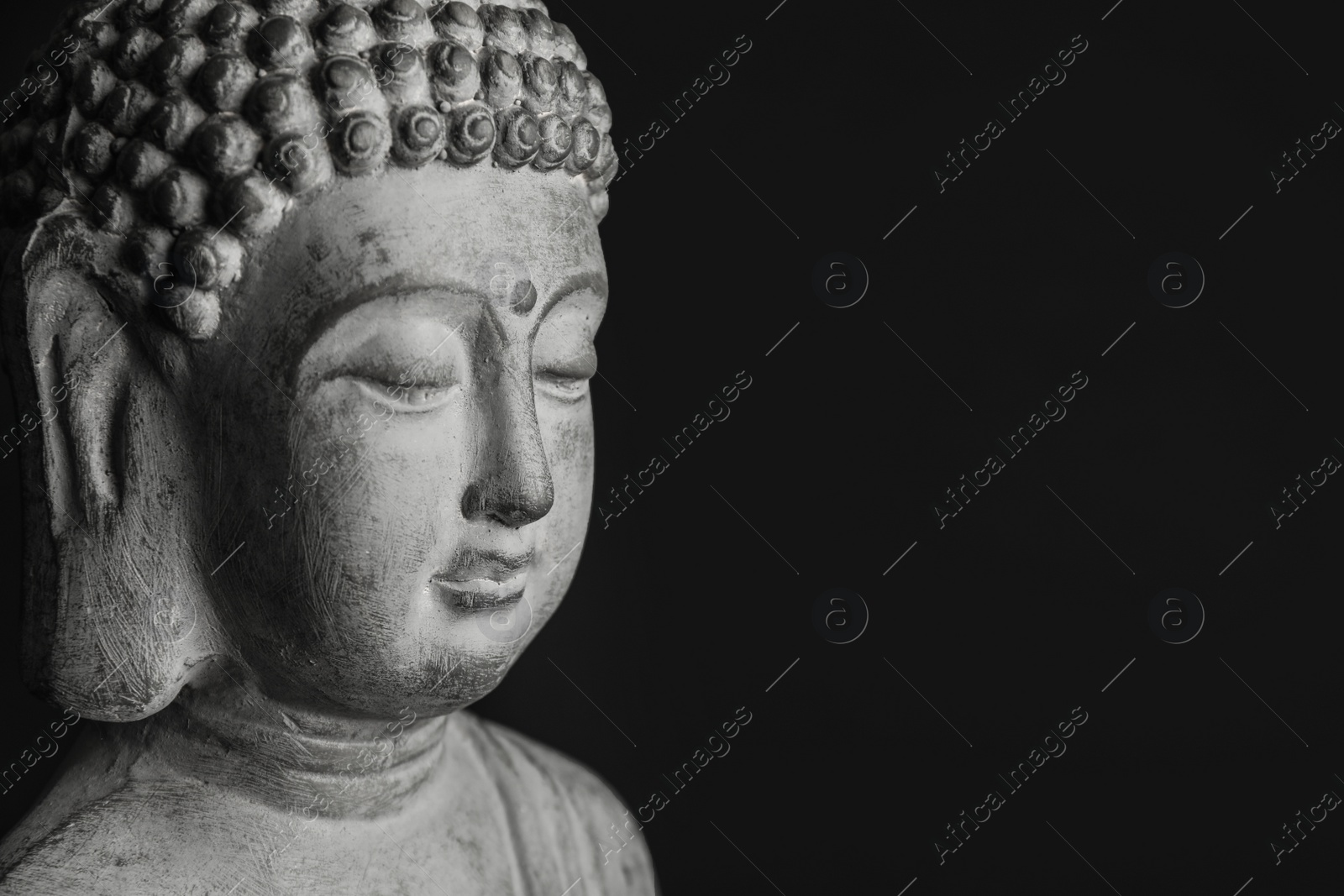 Photo of Beautiful stone Buddha sculpture on black background, closeup. Space for text