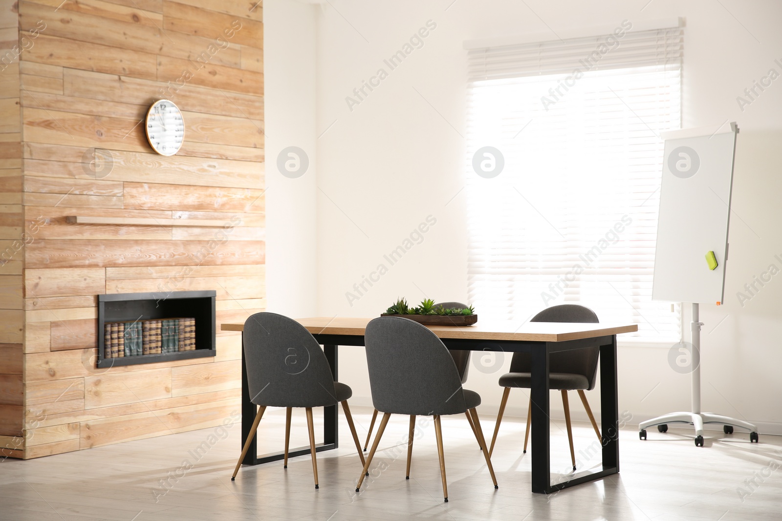 Photo of Modern meeting room interior with large table and chairs
