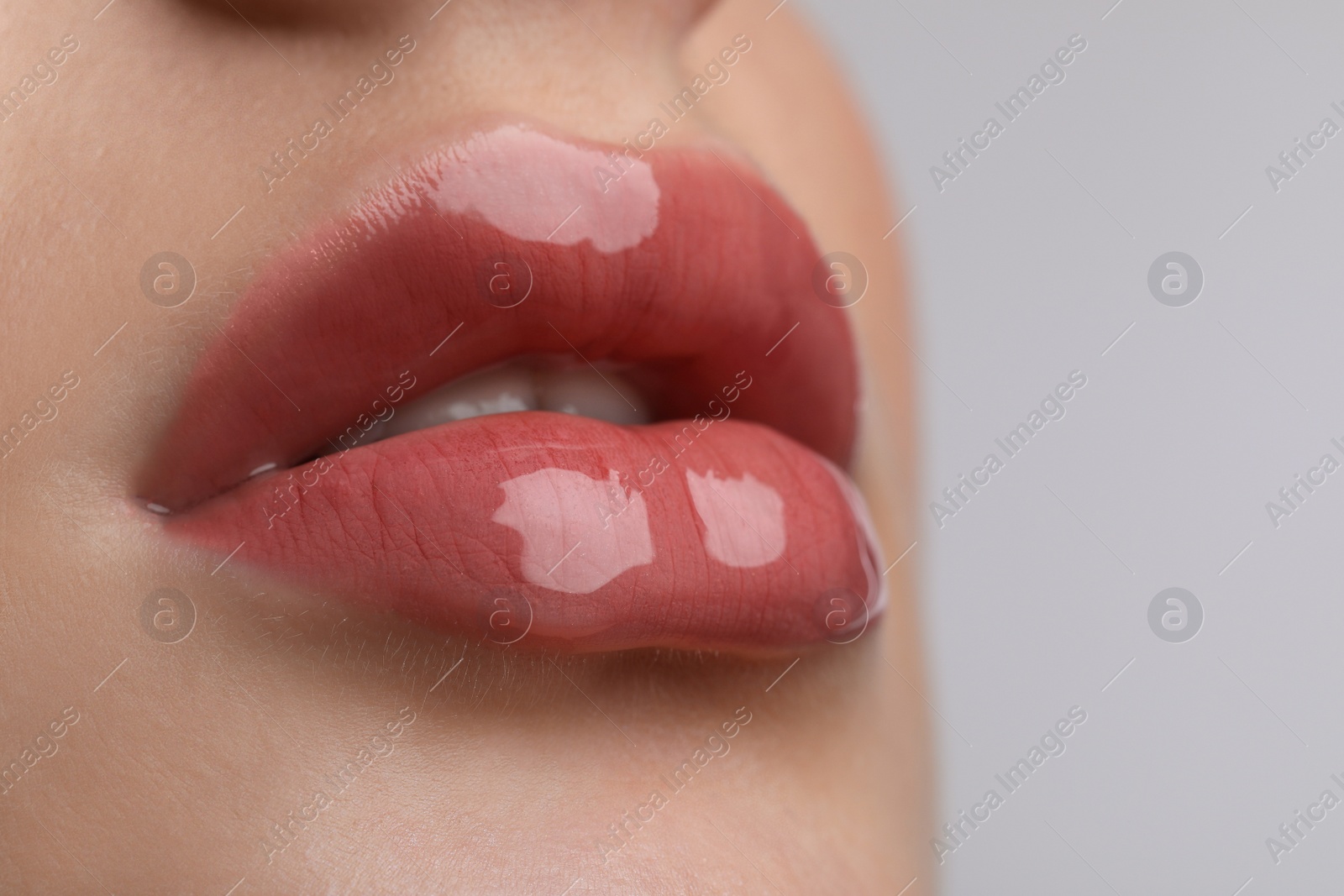 Photo of Closeup view of beautiful young woman with perfect lips makeup on light grey background