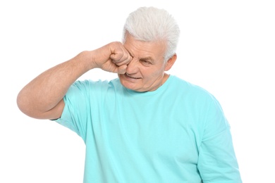 Photo of Mature man rubbing eye on white background. Annoying itch