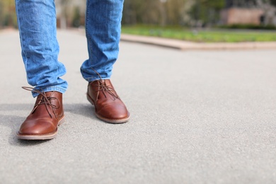 Photo of Man in elegant leather shoes outdoors, closeup