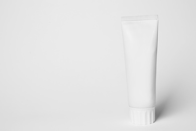 Photo of Blank tube of toothpaste on white background. Space for text